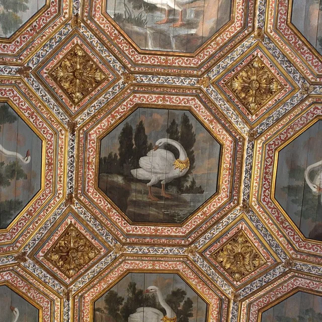 The painted ceiling of the Sala dos Cisnes in the Sintra National Palace, with gold-collared swans set in octagonal coffers.